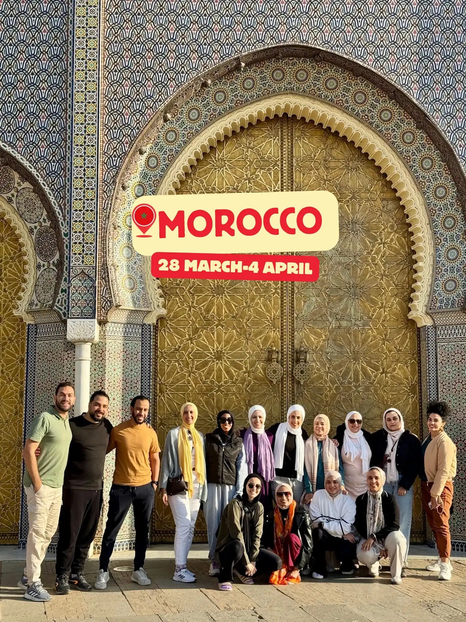 A group poses in front of an ornate golden door with intricate patterns and colorful mosaic tiles, likely at a historic site in Morocco